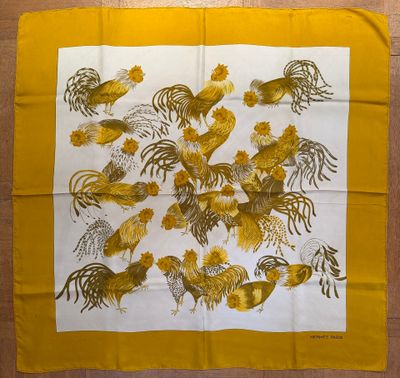 a close up of a yellow and white scarf with roosters on it