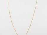 a gold necklace with a small pendant on a chain