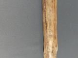 a wooden stick hanging on the wall of a room
