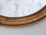 a mirror that is on the wall with a sky in the background