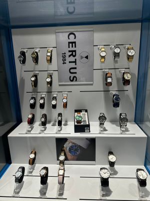 a lot of watches on display in a glass case