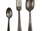 three spoons and a fork sitting next to each other