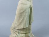 statue of a man in a cloak and cloak standing on a stone base