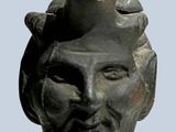 a statue of a man with a pipe on his head