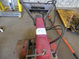 a red machine that is sitting in a room