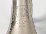 a silver bell that is sitting on a table