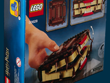 someone is holding a box of legos on a blue background