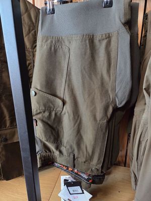 a pair of pants hanging on a rack in a room