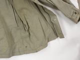 an image of a military jacket laying on top of a bed
