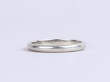 a close up of a silver ring on a white surface