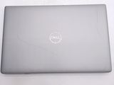 dell laptop with cracked screen on white table with white background