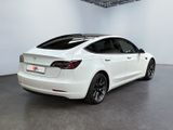 the tesla model s is parked in a large white room