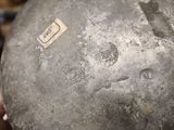 a close up of a metal object with a sticker on it