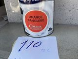 a close up of a can of orange sanding next to a piece of paper