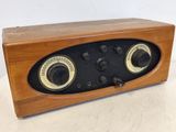 an old fashioned wooden radio sitting on top of a table