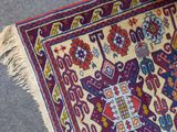 an image of a colorful rug with fringes laying on the floor