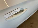 a close up of a car door handle with a sticker on it
