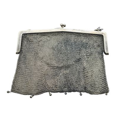 an old silver mesh purse on a white background