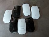four white apple mouses sitting on top of a table next to each other