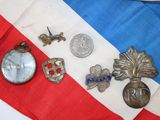 a lot of badges and a pocket watch on a flag