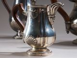 three silver vases sitting next to each other on a table