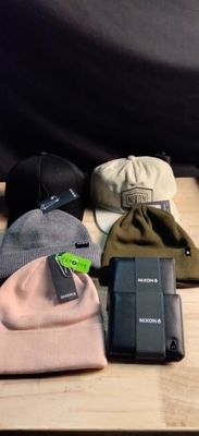 many hats that are sitting on a wooden table