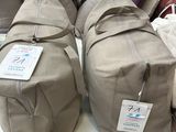 many bags of luggage sitting on a shelf in a store
