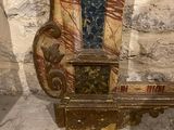 a wooden bench that has a clock on top of it
