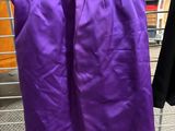 a purple skirt hanging on a rack in a store