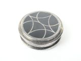 a black and white picture of a button on a white surface