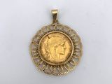 a gold coin with a woman ' s face in the center of it