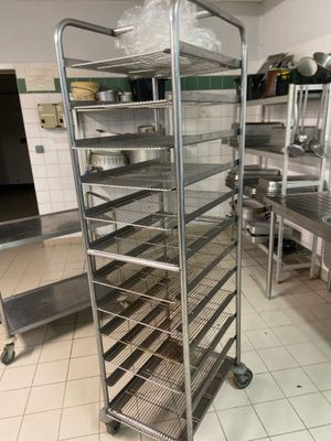 a large metal rack with many pans on it