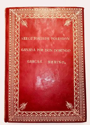 an old red book sitting on top of a white table