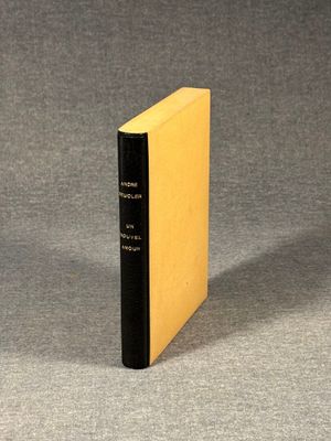 the book is sitting on a gray surface with a black cover