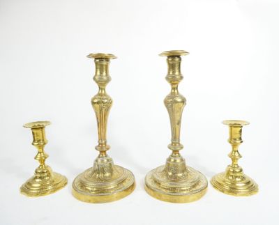 three brass candlesticks on a white background with a white background