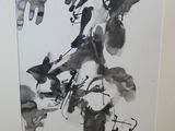 a black and white picture of a painting on the wall