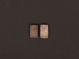 two pieces of silver are shown on a black surface