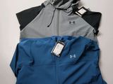a couple of jackets sitting on top of a table next to each other