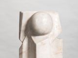 marble sculpture of a ball and a cube on a white surface