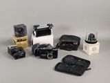many different types of cameras sitting on a table