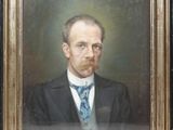 portrait d'un homme en costume-cravate dans un cadre doré