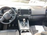 a dashboard of a car with a steering wheel and dashboard controls