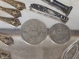 a lot of silver spoons and other silverware on a table