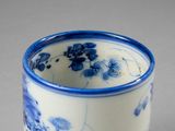 a blue and white cup sitting on a table