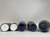 six bottles of wine are lined up in a row on a white surface