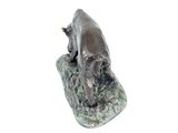 a statue of a dog that is sitting on a rock