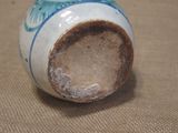 a blue and white vase sitting on a table