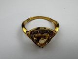 a gold ring with a brown stone in the middle of it