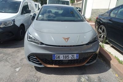 a silver car parked in a parking lot next to other cars