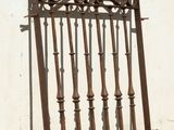 a metal fence that is leaning against a white wall